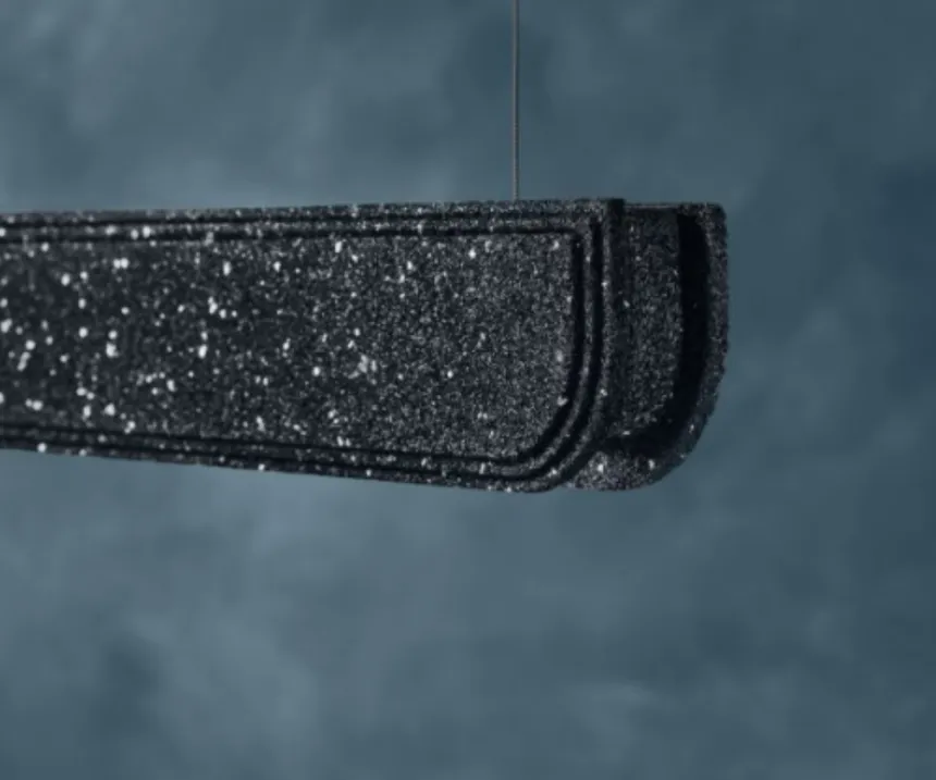Close view of a moulded recycled rubber profile, the granulate speckle visible