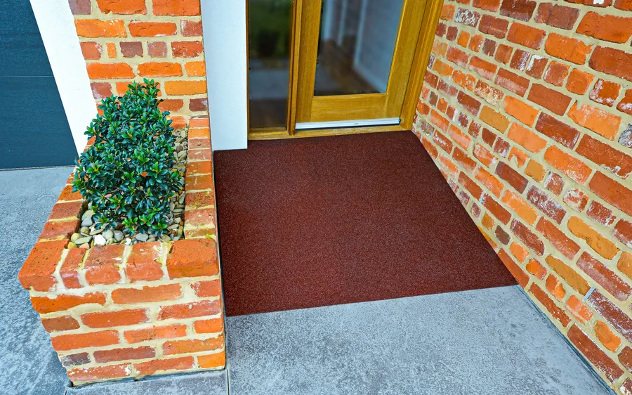 Brick red threshold surface colour-matched to a red brick entry
